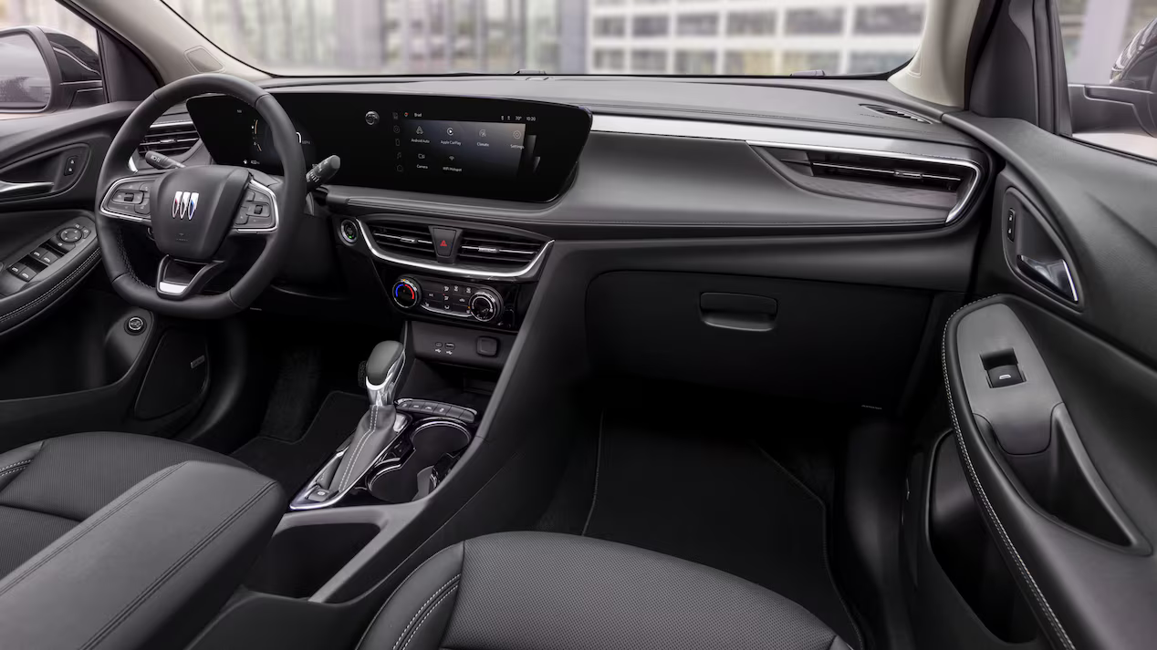 Interior of the 2026 Buick Encore GX showing the steering wheel, touchscreen display, and center console in a modern black finish.